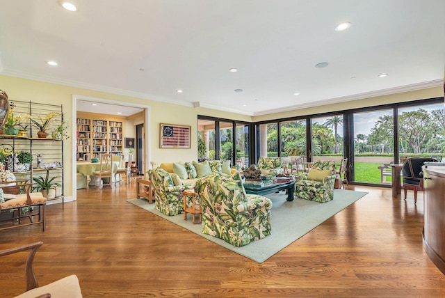 living room with ornamental molding, plenty of natural light, and light hardwood / wood-style flooring