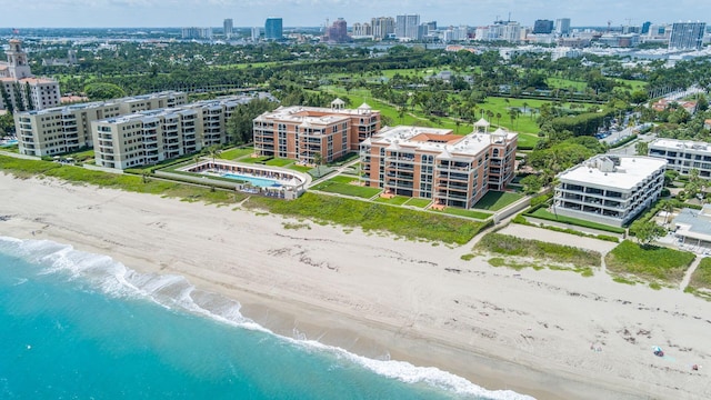 drone / aerial view featuring a beach view and a water view