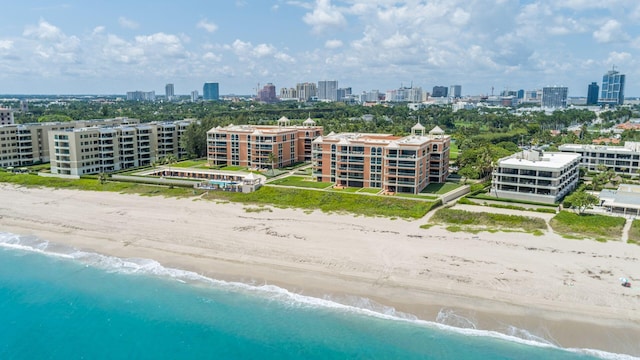 drone / aerial view featuring a beach view and a water view