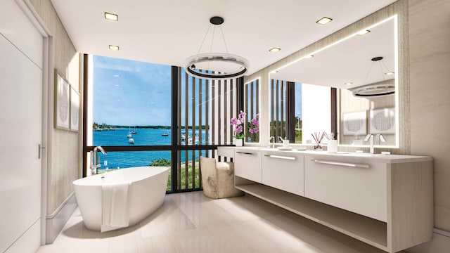 bathroom with a washtub, oversized vanity, expansive windows, a water view, and tile floors