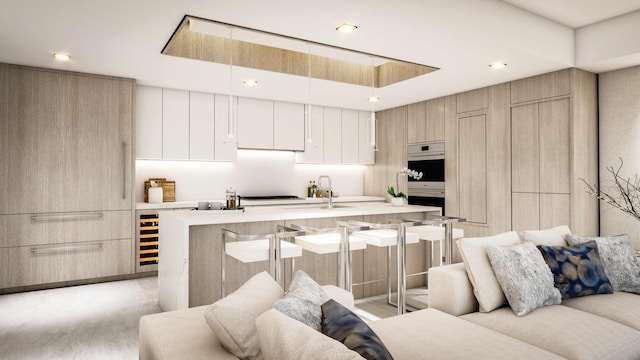 kitchen with an island with sink, hanging light fixtures, white cabinetry, and a breakfast bar