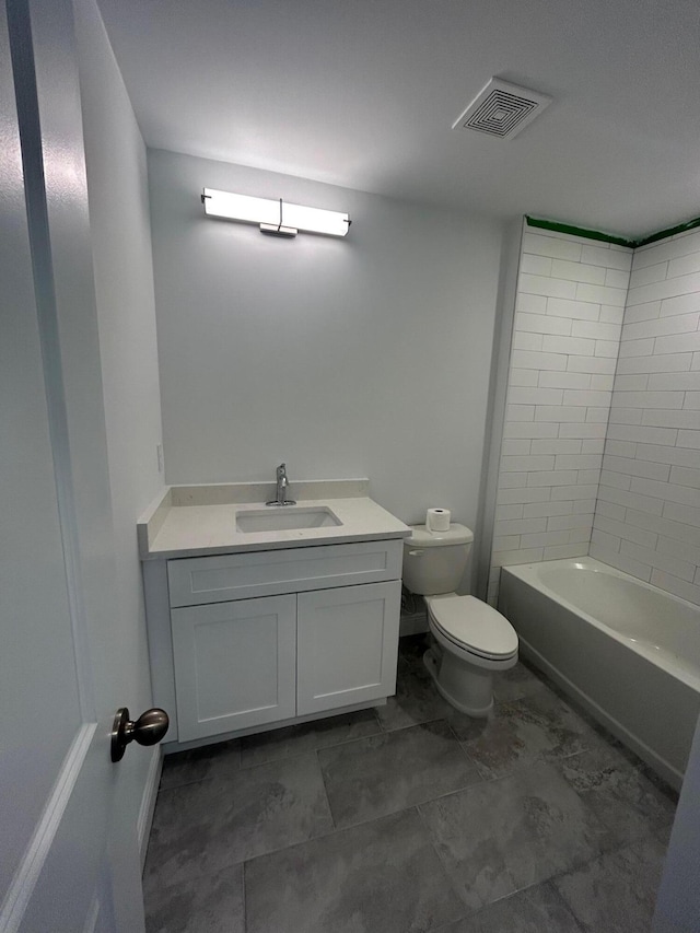 full bathroom featuring tiled shower / bath combo, vanity, tile floors, and toilet