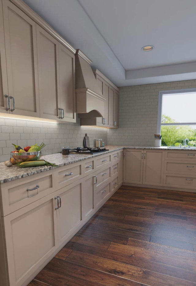 kitchen featuring dark hardwood / wood-style floors, backsplash, light stone countertops, and custom exhaust hood