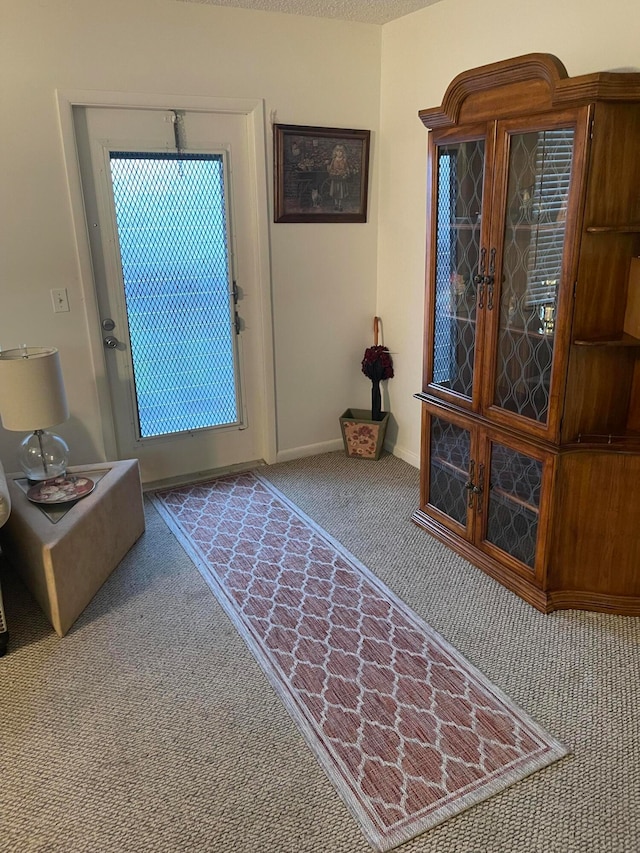 entryway featuring light carpet, french doors, and a healthy amount of sunlight