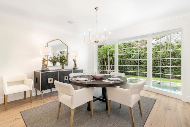 236 Pendleton Ave, Palm Beach, FL 33480 - dining area featuring a chandelier, ornamental molding, light wood-type flooring, and plenty of natural light