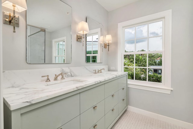 bathroom featuring a wealth of natural light, tile flooring, dual sinks, and large vanity