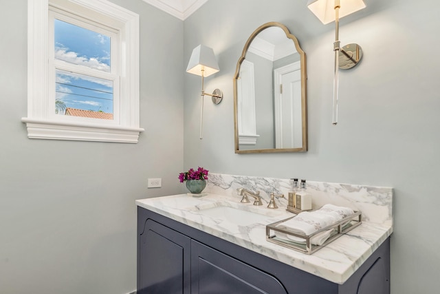 bathroom featuring ornamental molding and vanity