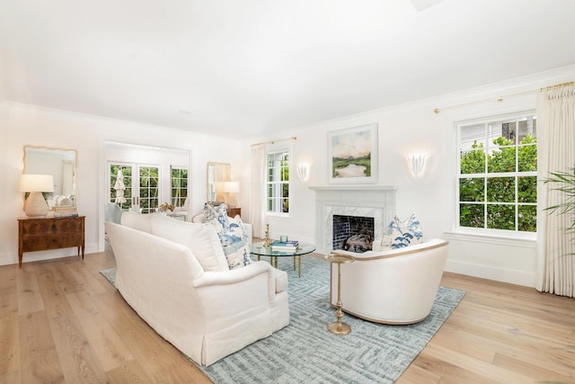 236 Pendleton Ave, Palm Beach, FL 33480 - living area featuring a high end fireplace, light wood-style floors, baseboards, and crown molding