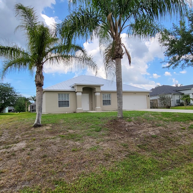 view of front facade featuring a front yard and a garage