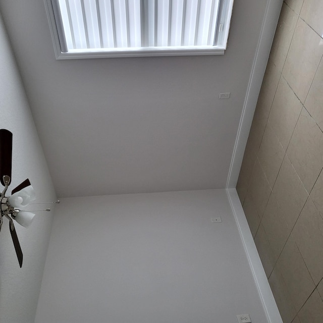 interior space with ceiling fan and a wealth of natural light