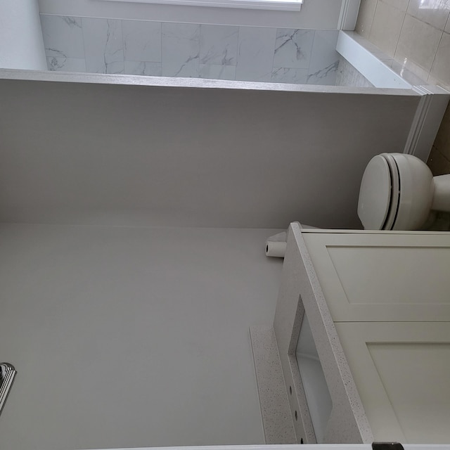 bathroom with toilet and vanity