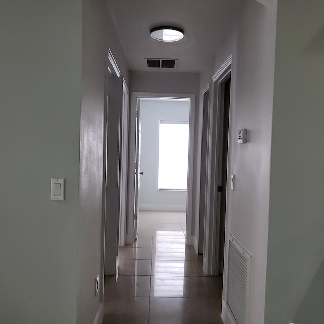 hallway featuring light tile flooring