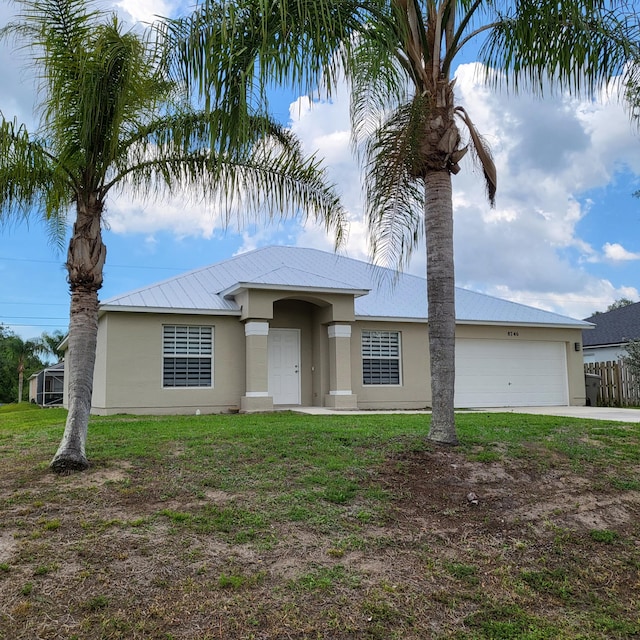 view of front facade with a front yard and a garage