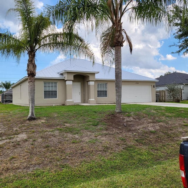 view of front of house featuring a front yard and a garage