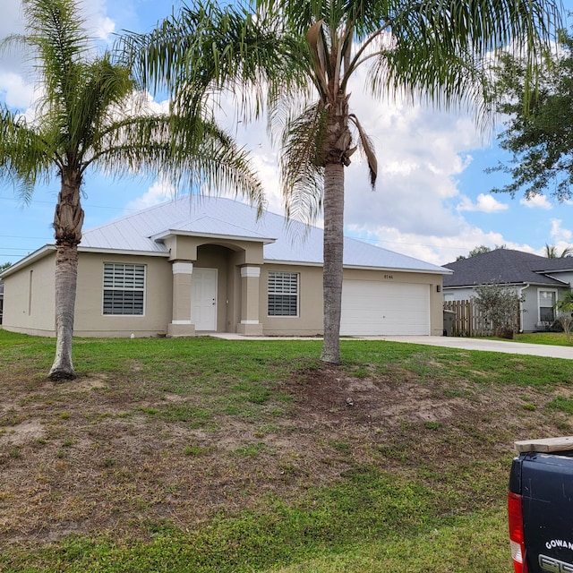 view of front of house with a front lawn and a garage