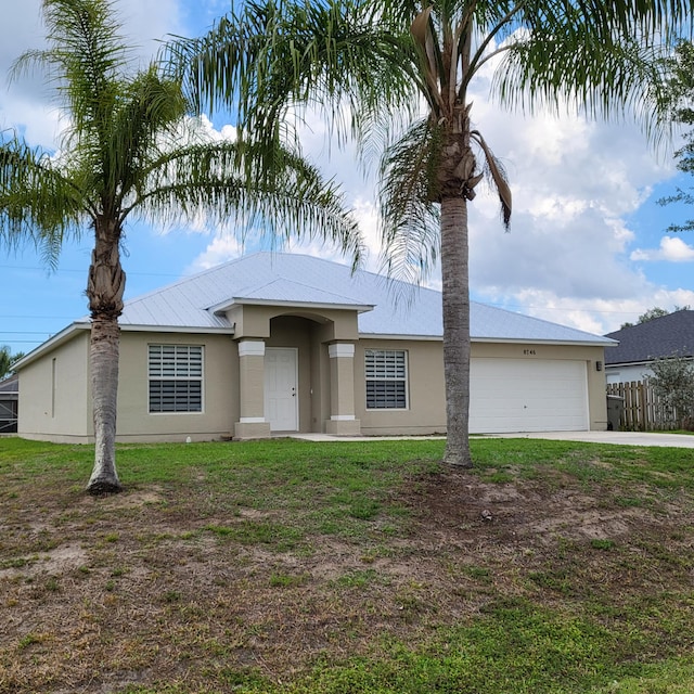 view of front of home with a front lawn and a garage