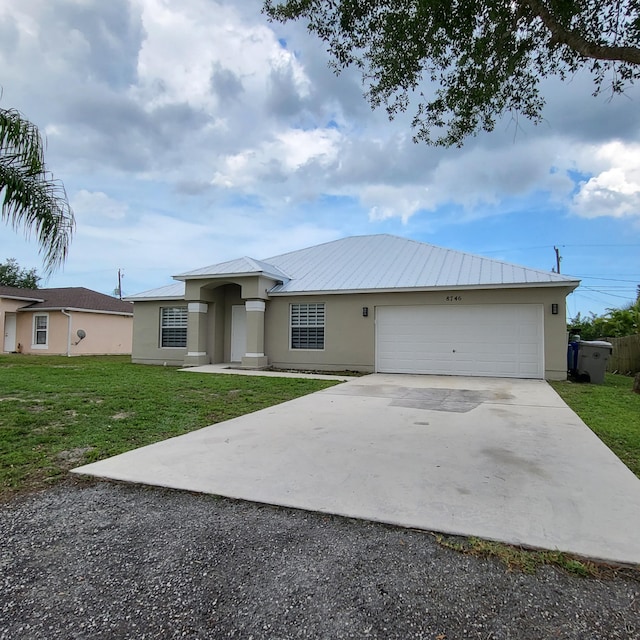 view of front of home featuring a front yard and a garage