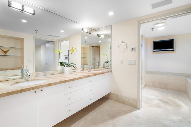 bathroom featuring tile patterned flooring, built in shelves, and vanity