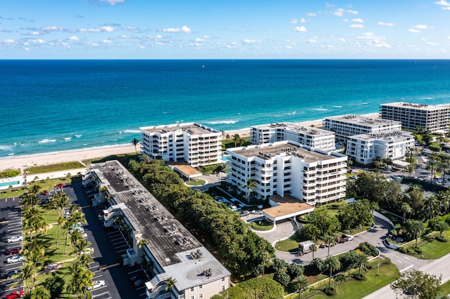 drone / aerial view featuring a beach view and a water view