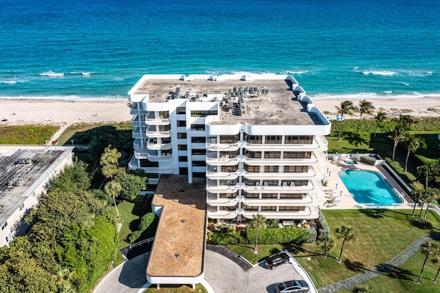 drone / aerial view with a water view and a beach view