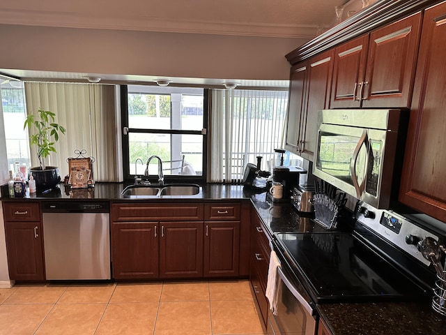 kitchen with light tile floors, ornamental molding, sink, and stainless steel appliances