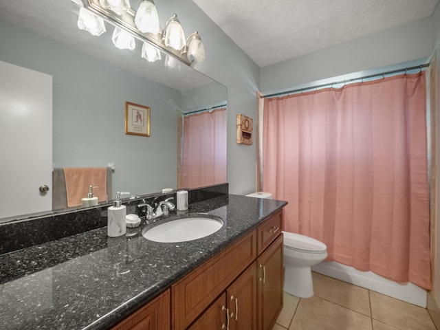 bathroom featuring oversized vanity, toilet, a textured ceiling, and tile floors