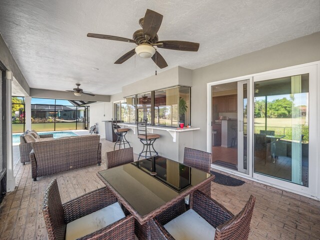 sunroom with ceiling fan