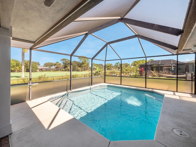 view of swimming pool featuring a patio area and glass enclosure