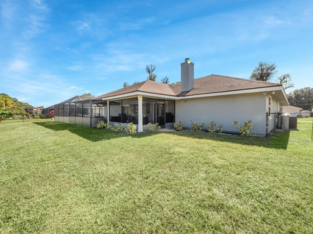 back of property featuring a yard