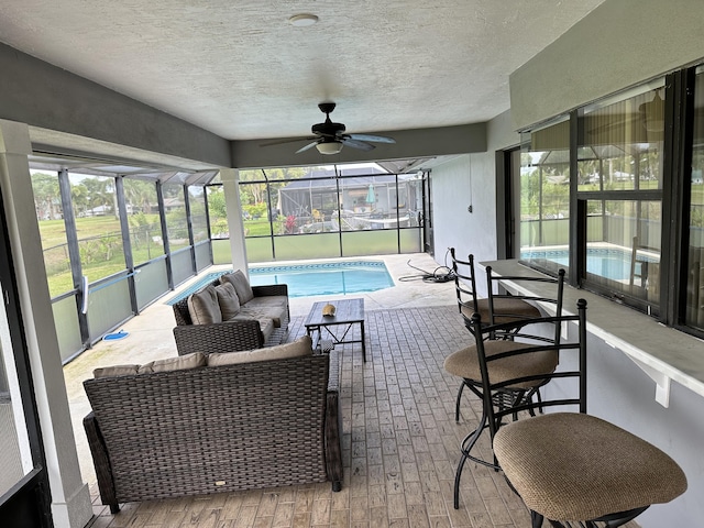 sunroom featuring ceiling fan