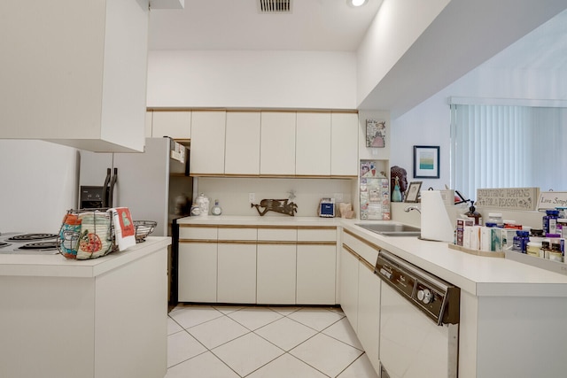 kitchen with light tile floors, kitchen peninsula, dishwasher, and sink