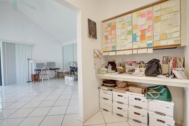 interior space with tile floors, ceiling fan, and vaulted ceiling