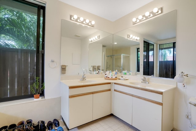 bathroom featuring tile floors and dual bowl vanity