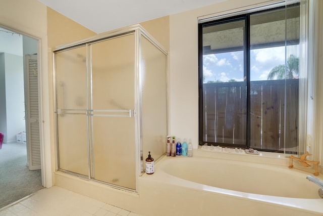 bathroom with separate shower and tub and tile flooring