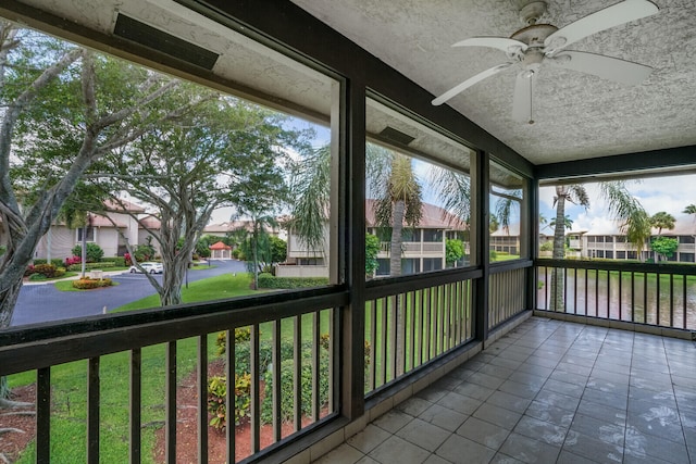 unfurnished sunroom featuring ceiling fan