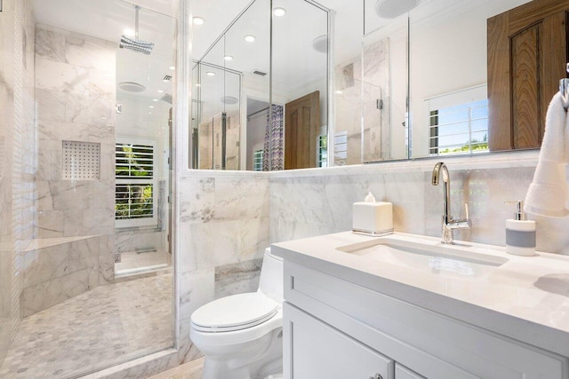 bathroom with an enclosed shower, vanity, toilet, and tile walls