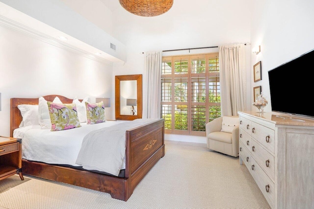 bedroom with light colored carpet, access to outside, and multiple windows