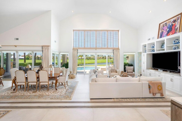 living room with high vaulted ceiling, light tile floors, and a wealth of natural light