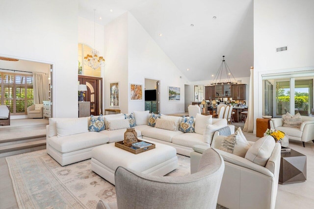 tiled living room with high vaulted ceiling and an inviting chandelier