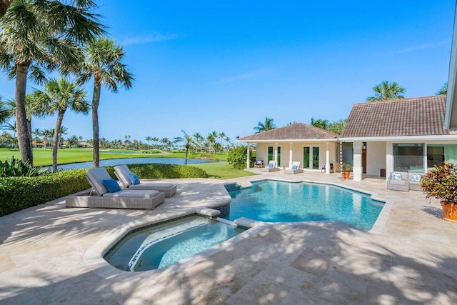 view of pool featuring a lawn, a patio, and an in ground hot tub