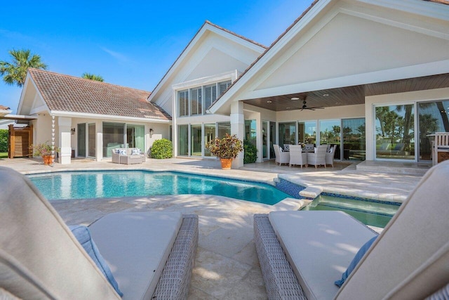 view of swimming pool with outdoor lounge area, ceiling fan, and a patio