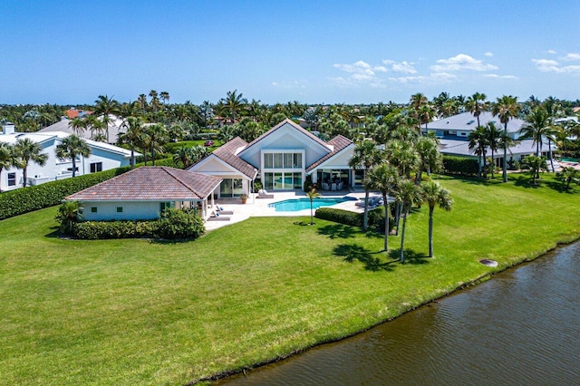 exterior space with a water view, a patio area, and a yard