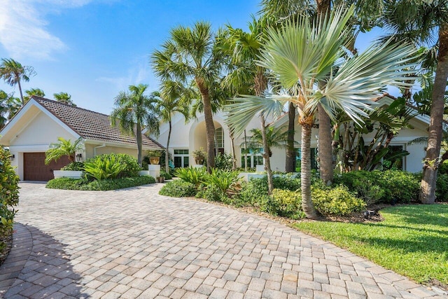 view of front facade with a front yard and a garage