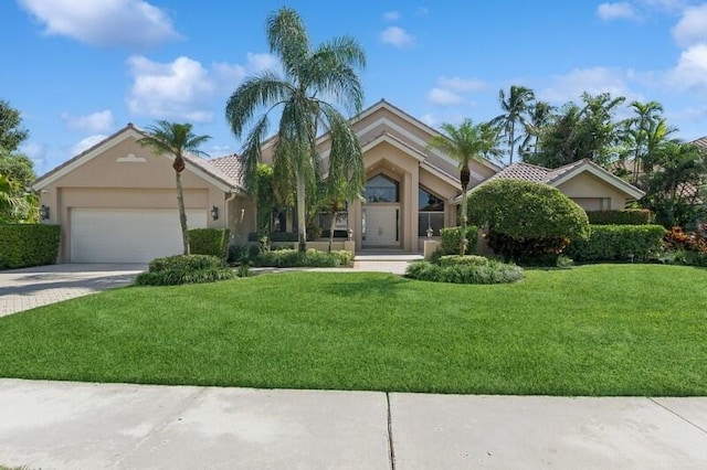 view of front of house featuring a front yard and a garage