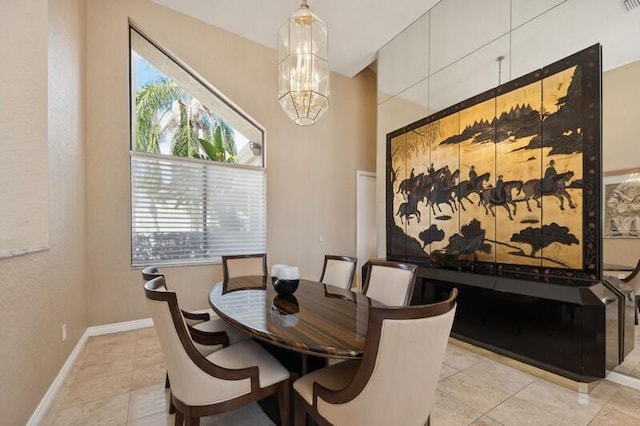 dining area featuring light tile patterned flooring, a wealth of natural light, and an inviting chandelier