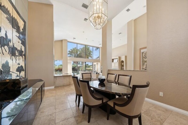 dining space with a notable chandelier and a high ceiling