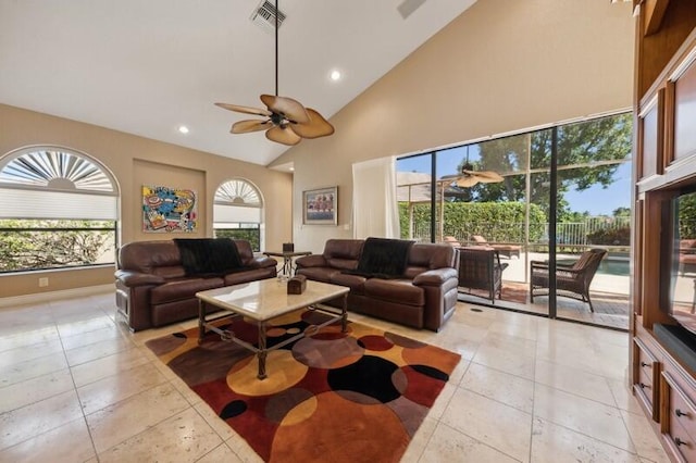 living room with ceiling fan, high vaulted ceiling, and a wealth of natural light