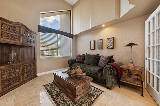 tiled living room featuring a wealth of natural light and lofted ceiling