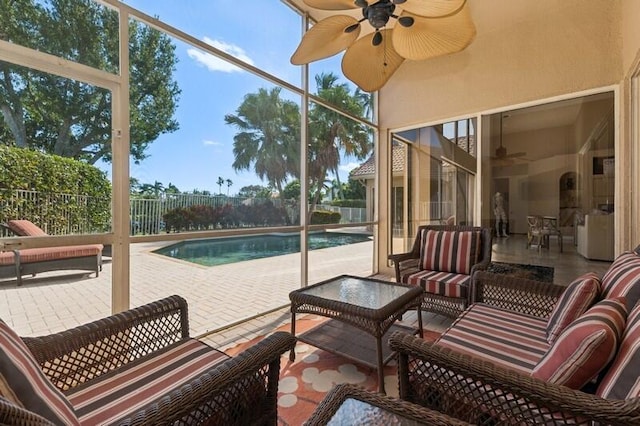 sunroom / solarium featuring a swimming pool and ceiling fan