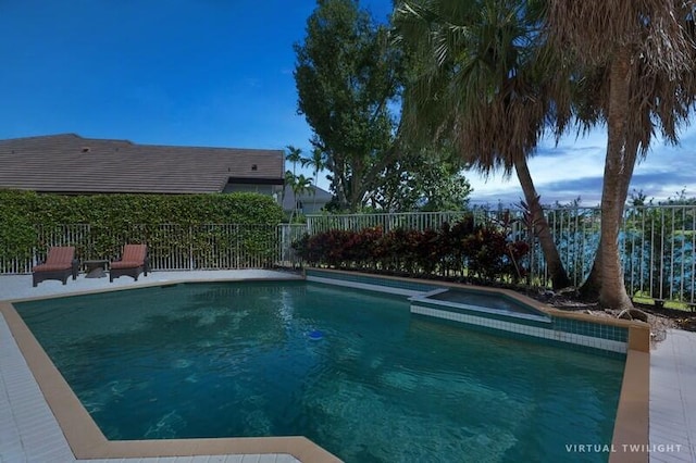 view of swimming pool featuring an in ground hot tub